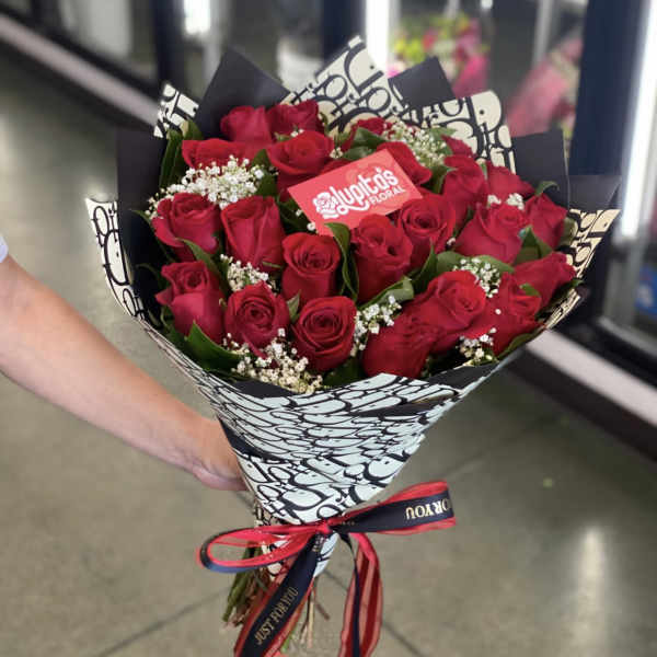 Bouquet of red roses wrapped in black-and-white paper