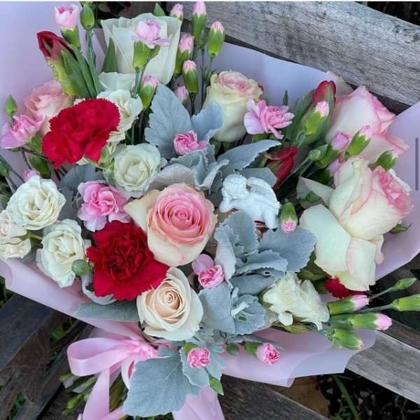 Bouquet of pink and white roses with red carnations and pale blue foliage