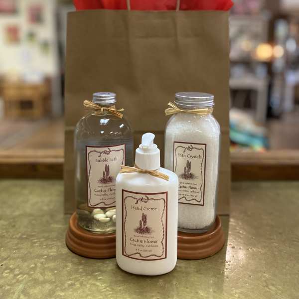 Gift bag with bath products and red tissue paper