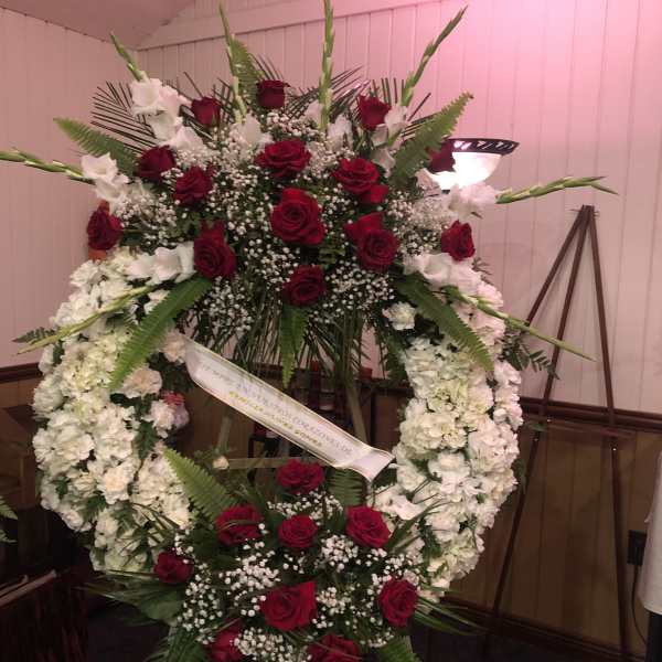 Large funeral wreath of red roses and white flowers