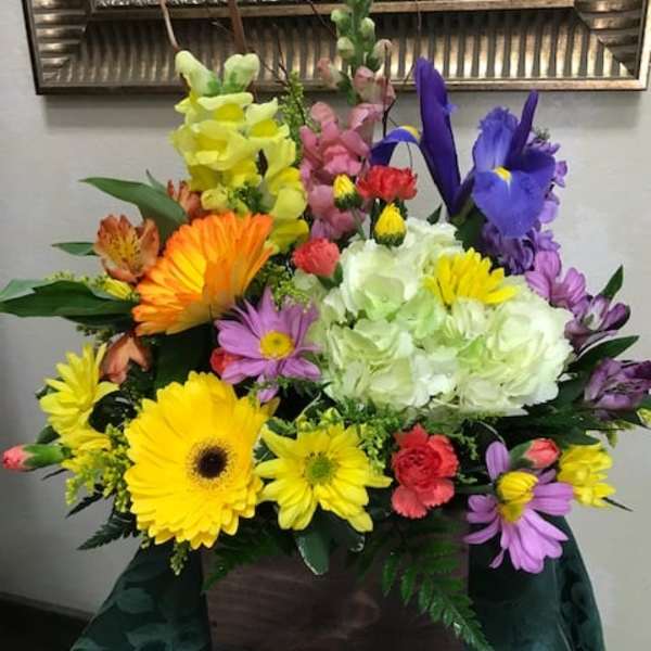 Colorful mixed flower arrangement in a wooden box