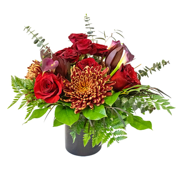 Red roses and a chrysanthemum in a black vase