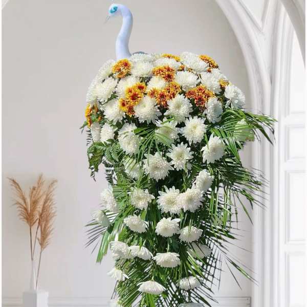 Tall floral peacock arrangement with white and yellow chrysanthemums