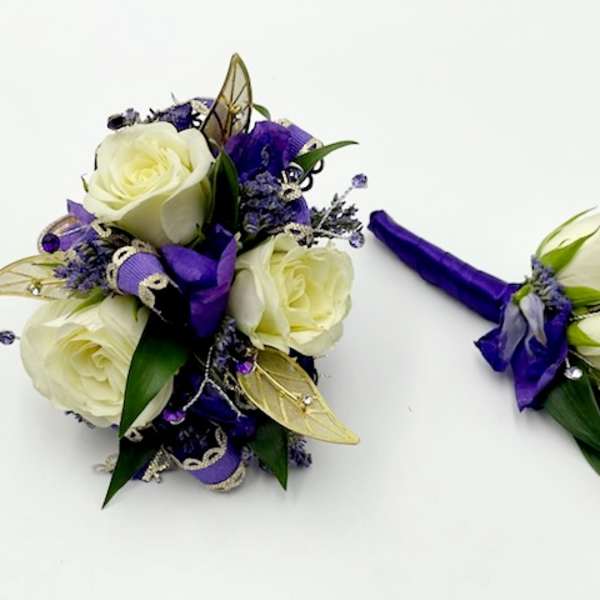 White rose bouquet and matching boutonniere with purple ribbon