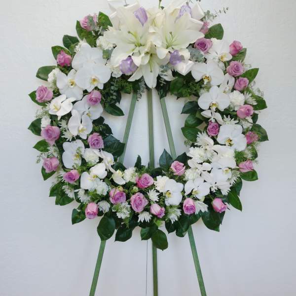 White and pink floral wreath on a standing easel