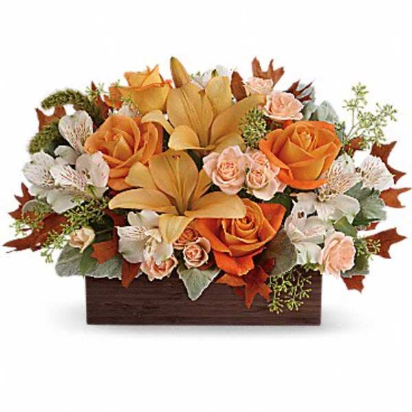 Orange and cream floral arrangement in a rectangular wooden box