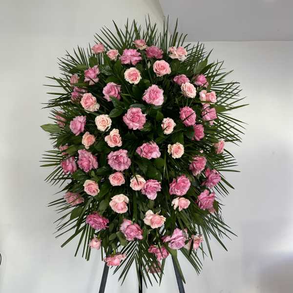 Standing spray of pink roses with palm fronds