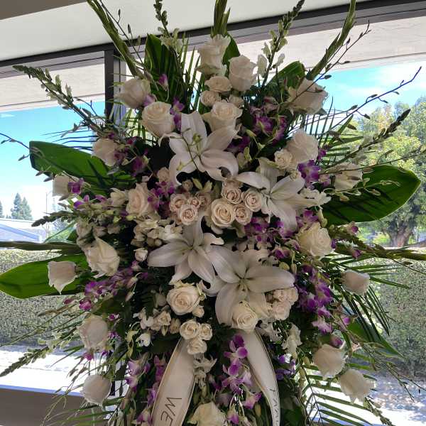 Large white floral standing spray with roses and lilies
