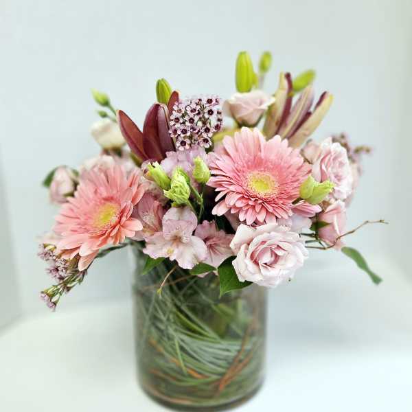 Pink and white mixed flower bouquet in a glass vase