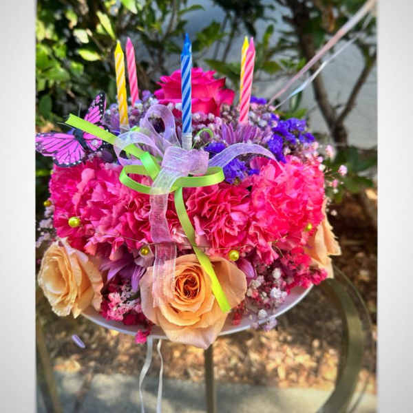 Bright bouquet with roses, carnations, and candles