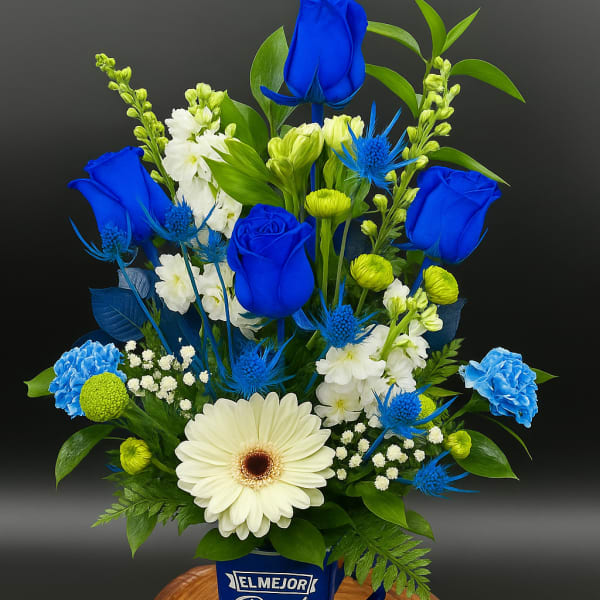 Blue and white mixed flower arrangement in a blue best dad mug on a wooden base