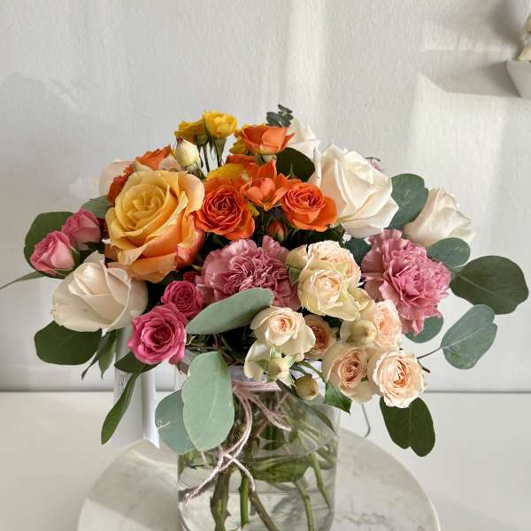Mixed roses and carnations in a glass vase