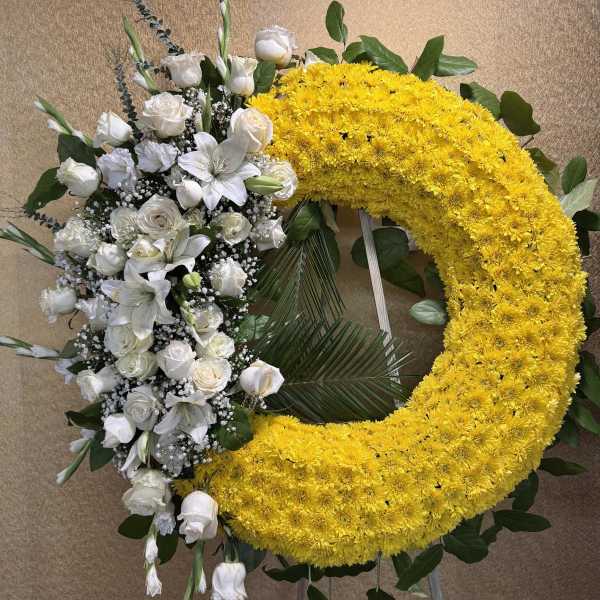 Yellow chrysanthemum wreath with white roses and lilies