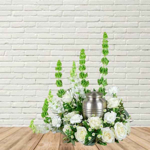 White floral arrangement with a silver urn centerpiece