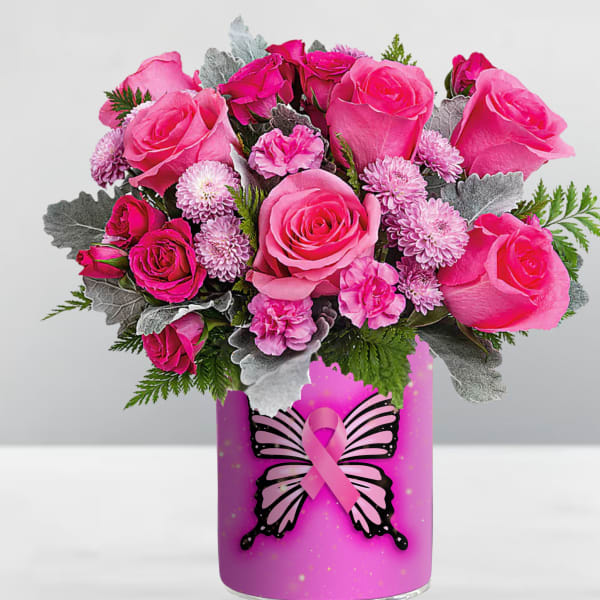 Pink roses and small pink flowers in a decorated vase with a ribbon graphic