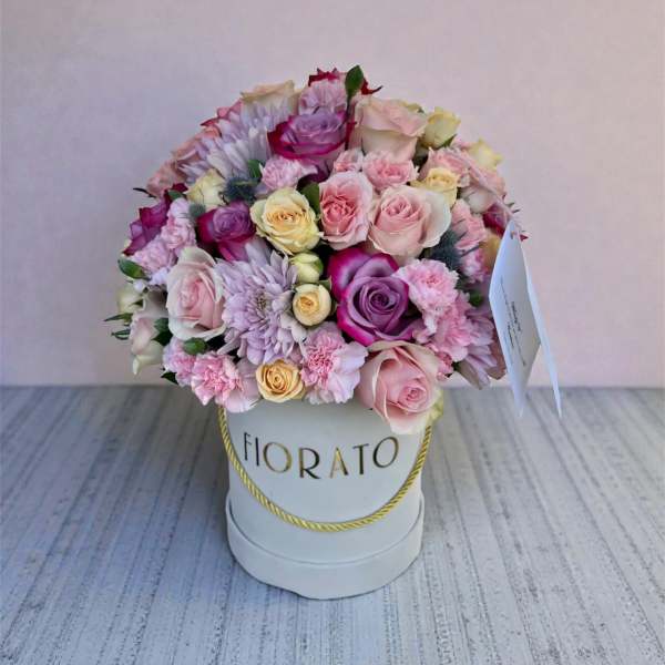 Pink and lavender rose bouquet in a white hat box