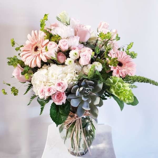 Pink and white mixed flower bouquet in a clear glass vase