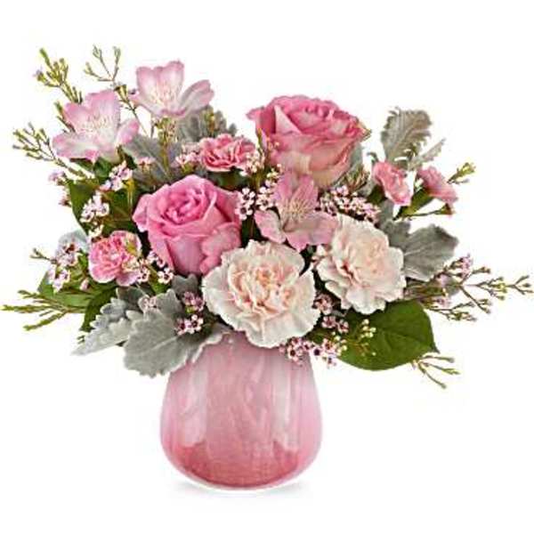 Pink and white flower arrangement in a pink glass vase