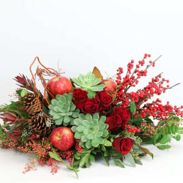 Red roses with apples, succulents, pinecones, and berry branches