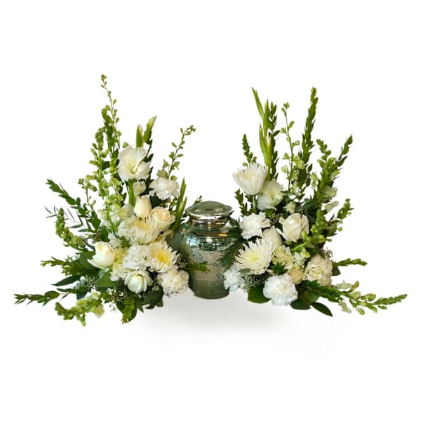 White floral arrangement flanking a silver urn