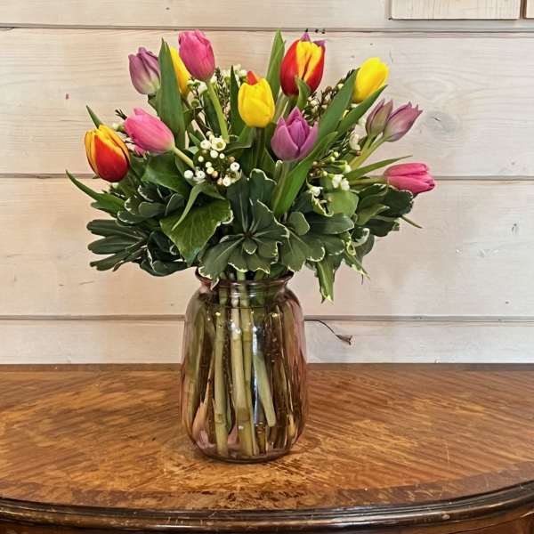 Colorful tulip bouquet in a glass vase