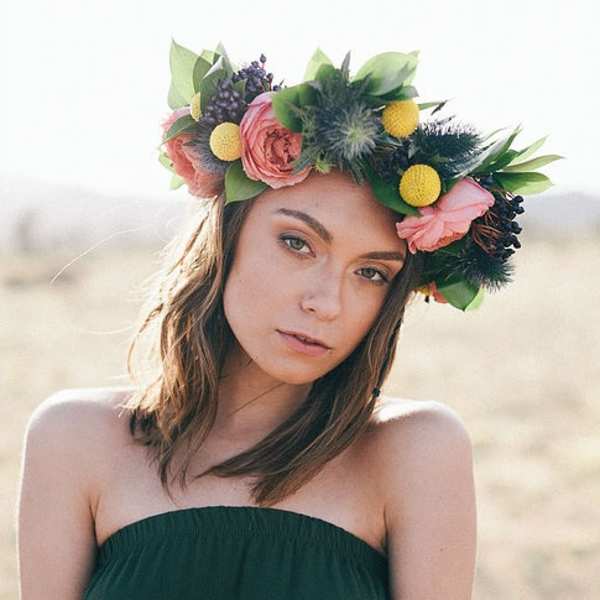 Woman wearing a floral crown with pink and yellow flowers
