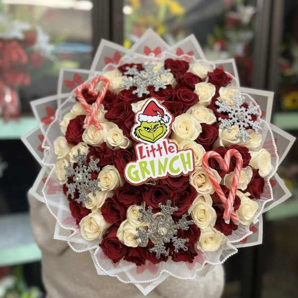 Bouquet of red and cream roses with candy canes and snowflake decorations