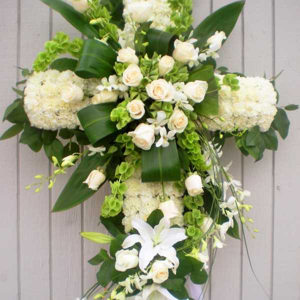 White floral cross arrangement with roses and lilies