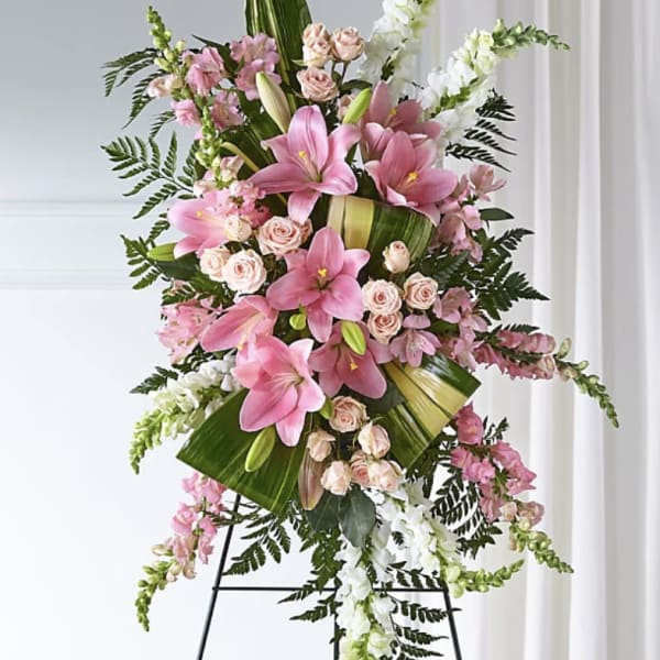 Standing floral spray with pink lilies, roses, and white snapdragons