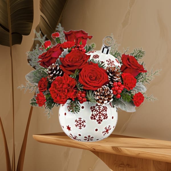 Red roses and carnations in a white snowflake vase
