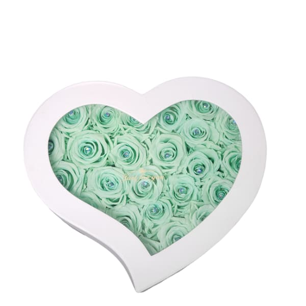 Heart-shaped box filled with mint green roses