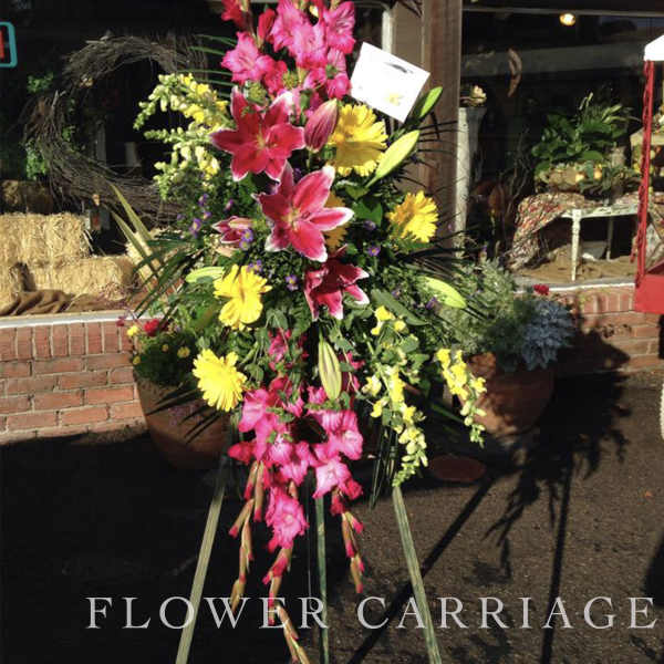 Tall standing floral spray with pink lilies and yellow daisies