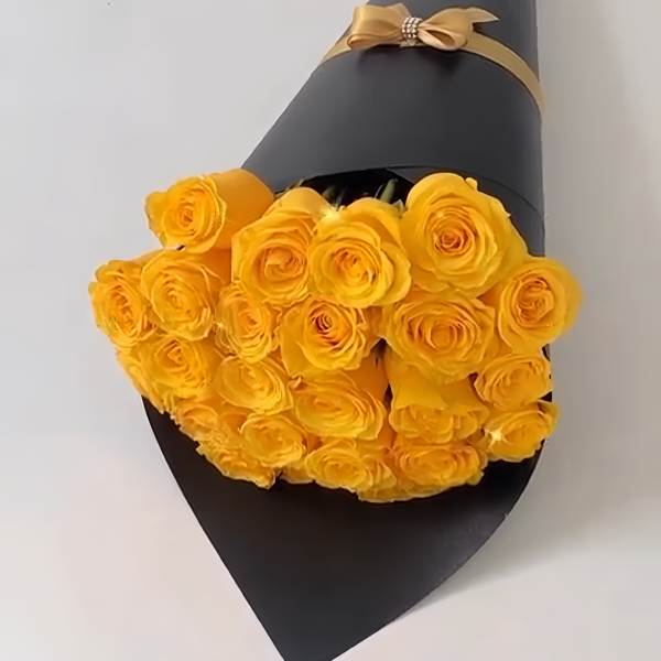 Bouquet of yellow roses wrapped in black paper with a gold ribbon