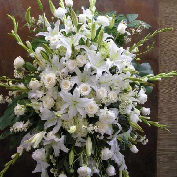 Large white floral spray with lilies and roses