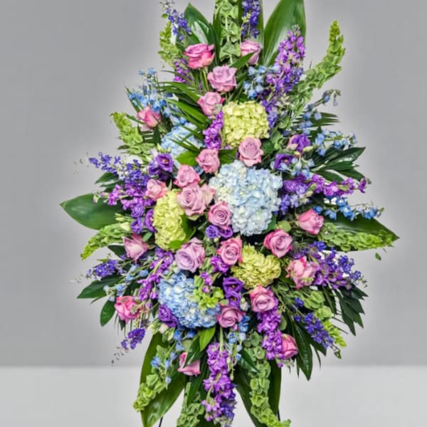 Large standing spray of pink, purple, blue, and green flowers