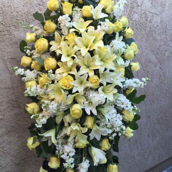Standing floral spray with yellow roses and white lilies
