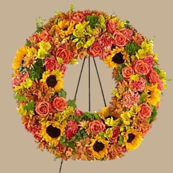 Circular wreath of mixed flowers on a stand