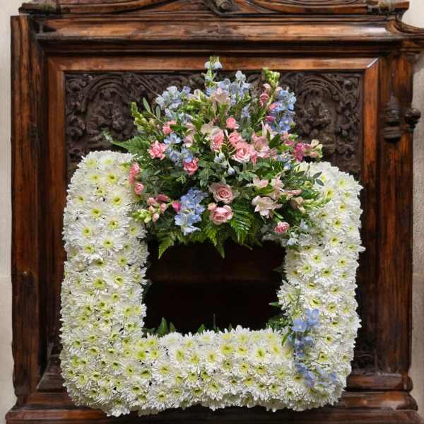 Square floral wreath with white daisies and pastel pink and blue flowers