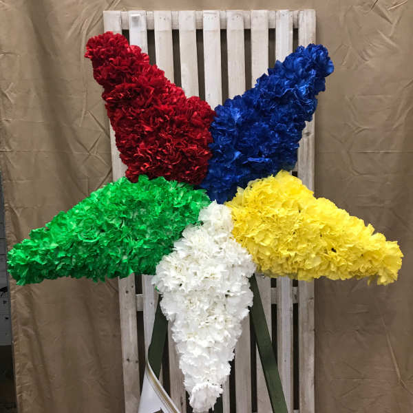 Five large floral sprays in red, blue, green, yellow, and white on a wooden backdrop.