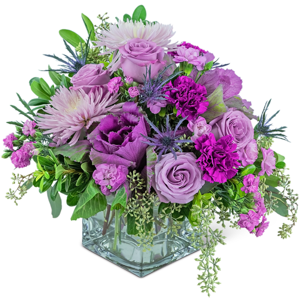 Lavender and purple mixed bouquet in a square glass vase