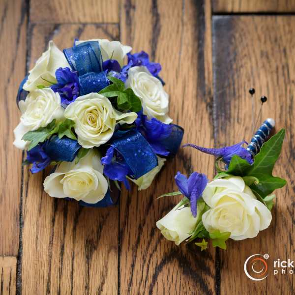 White rose bouquet and matching boutonniere with blue ribbon accents