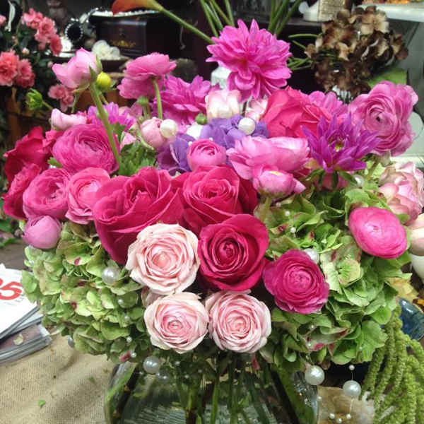 Pink and purple flower arrangement in a glass vase