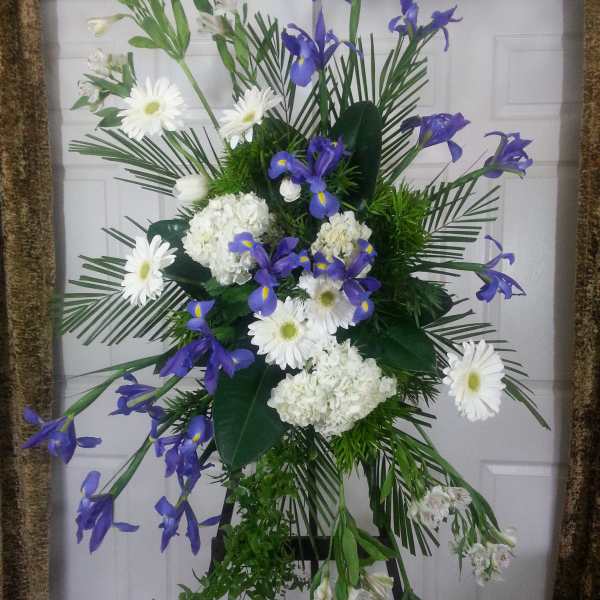 Standing floral spray with white daisies, hydrangeas, and purple irises
