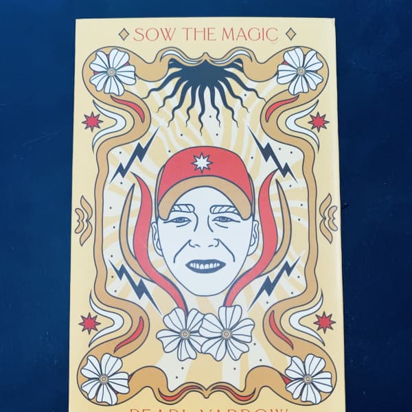 Illustrated book cover with a stylized face and floral motifs
