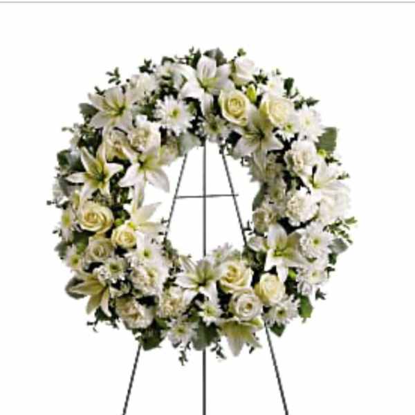 White floral wreath on a metal easel