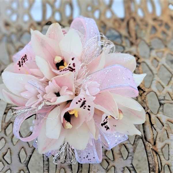 Small pink and white orchid corsage with ribbon accents