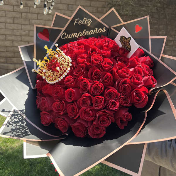 Large bouquet of red roses with a gold crown and birthday sign