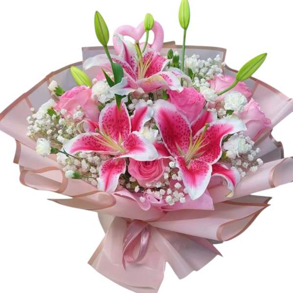 Pink lilies and roses wrapped in pale pink paper