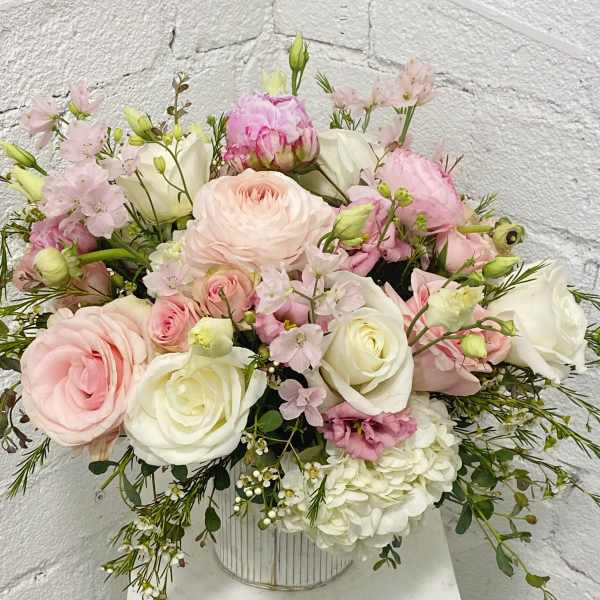 Pink and white mixed bouquet in a striped metal vase