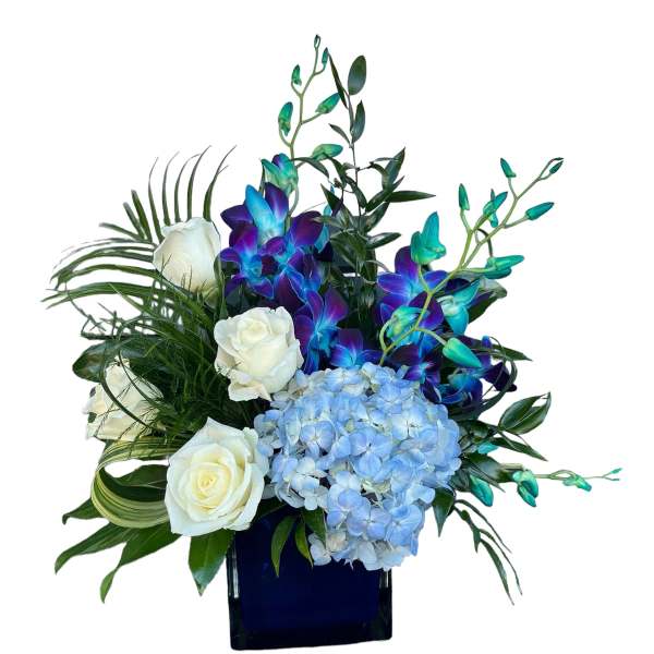 White roses and blue hydrangea in a dark vase with purple-blue orchids